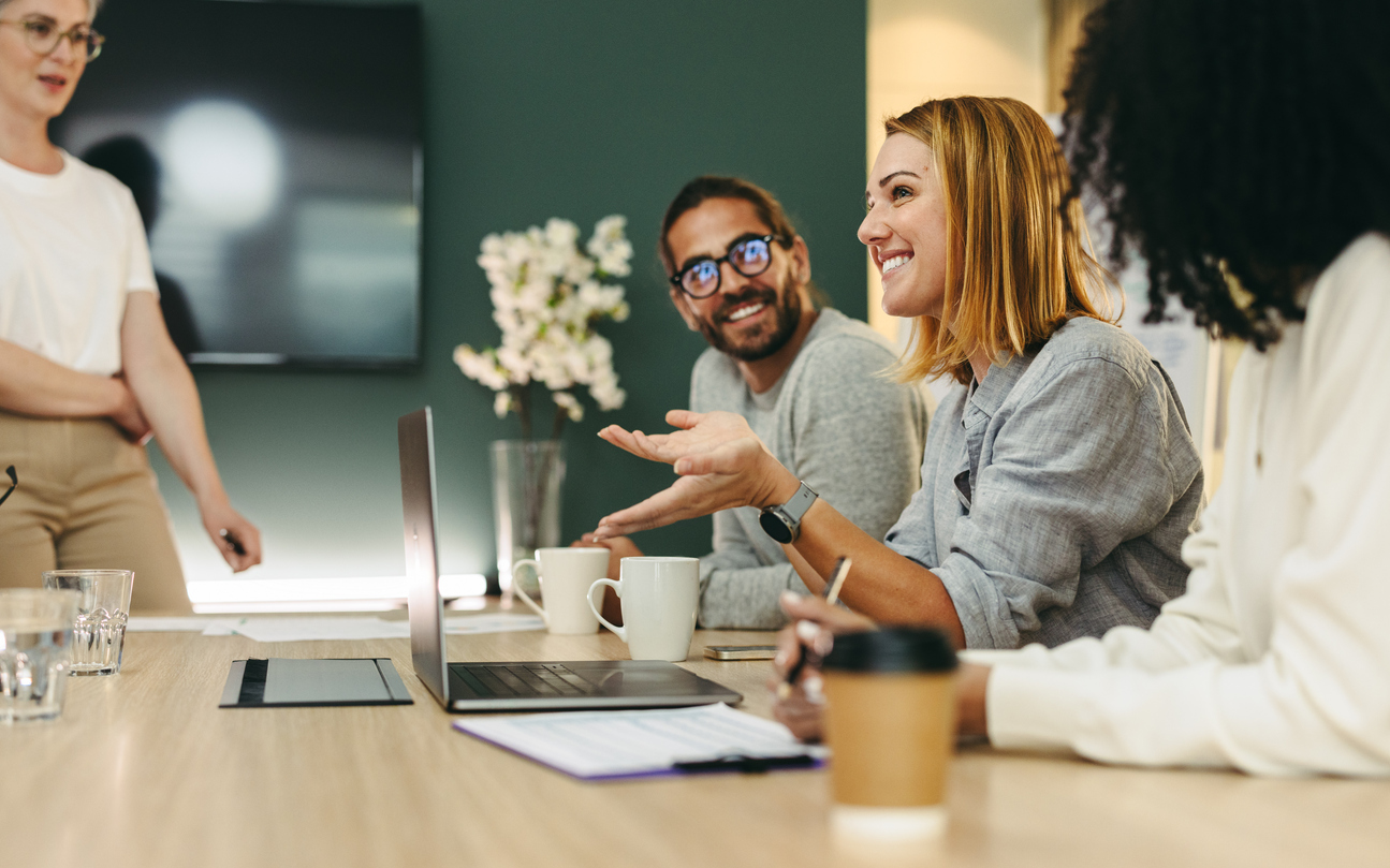Friendly and professional image showing diverse employees happily collaborating